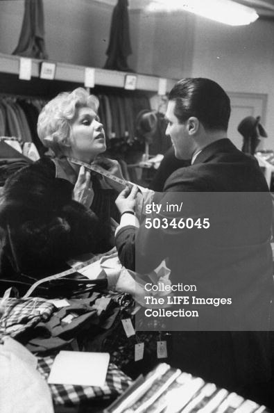 Kim Novak gets measured for a men’s shirt